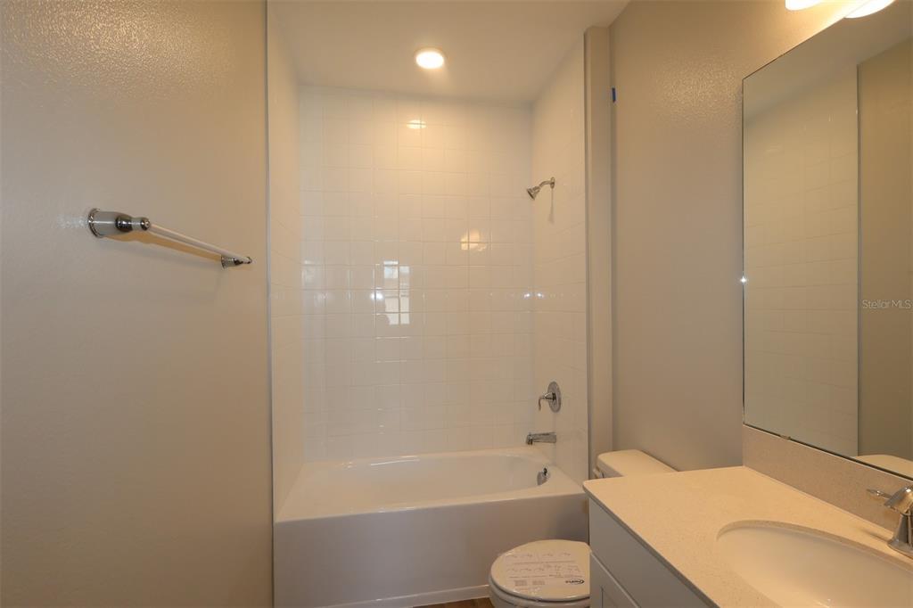 5184 Prairie Preserve Run St. Cloud, FL 34772 - Photo 19 of 36 a bathroom with a sink toilet and shower