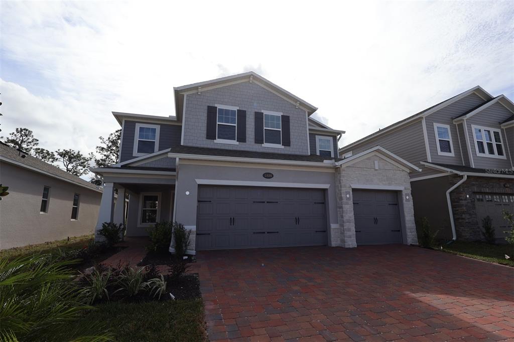 5184 Prairie Preserve Run St. Cloud, FL 34772 - Photo 2 of 36 a front view of house with a garden