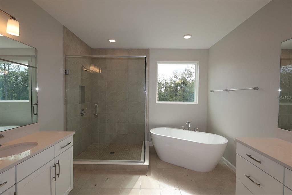 5184 Prairie Preserve Run St. Cloud, FL 34772 - Photo 23 of 36 a bathroom with a granite countertop toilet a sink and shower