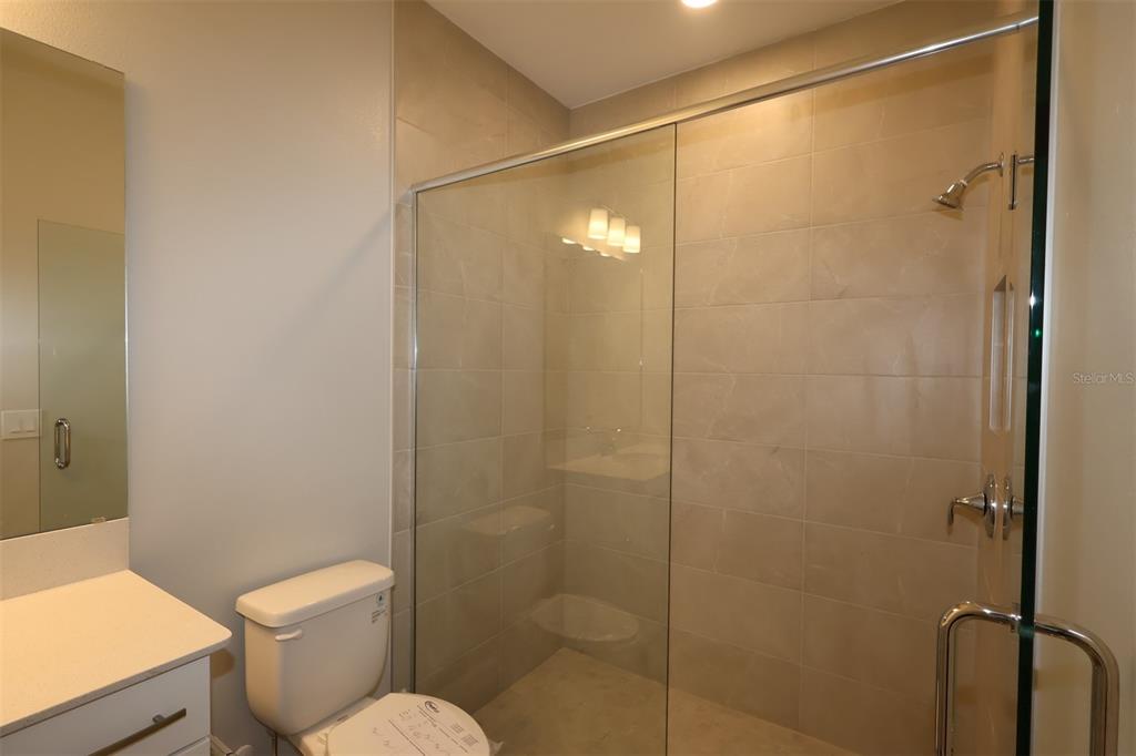 5184 Prairie Preserve Run St. Cloud, FL 34772 - Photo 26 of 36 a bathroom with a shower a toilet and a sink
