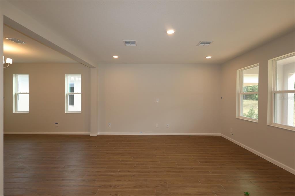 5184 Prairie Preserve Run St. Cloud, FL 34772 - Photo 29 of 36 an empty room with wooden floor and windows