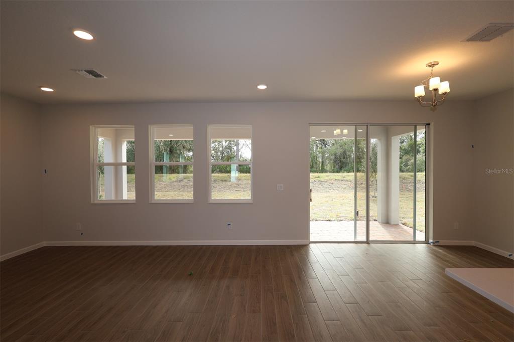 5184 Prairie Preserve Run St. Cloud, FL 34772 - Photo 30 of 36 a view of an empty room with wooden floor and a window