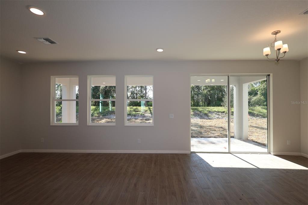 5184 Prairie Preserve Run St. Cloud, FL 34772 - Photo 31 of 36 a view of an empty room with wooden floor and a window