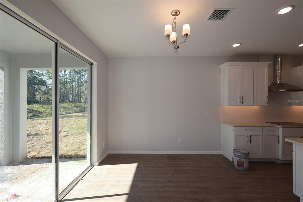 5184 Prairie Preserve Run St. Cloud, FL 34772 - Photo 32 of 36 a view of a kitchen with furniture and a floor to ceiling window