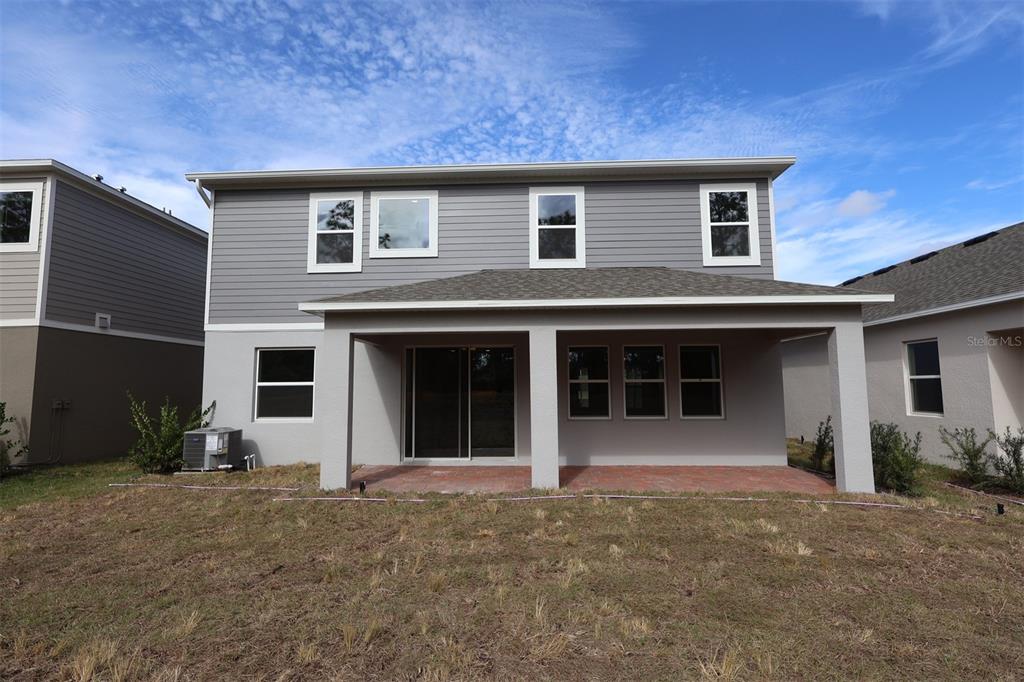 5184 Prairie Preserve Run St. Cloud, FL 34772 - Photo 33 of 36 a front view of a house with a yard and garage