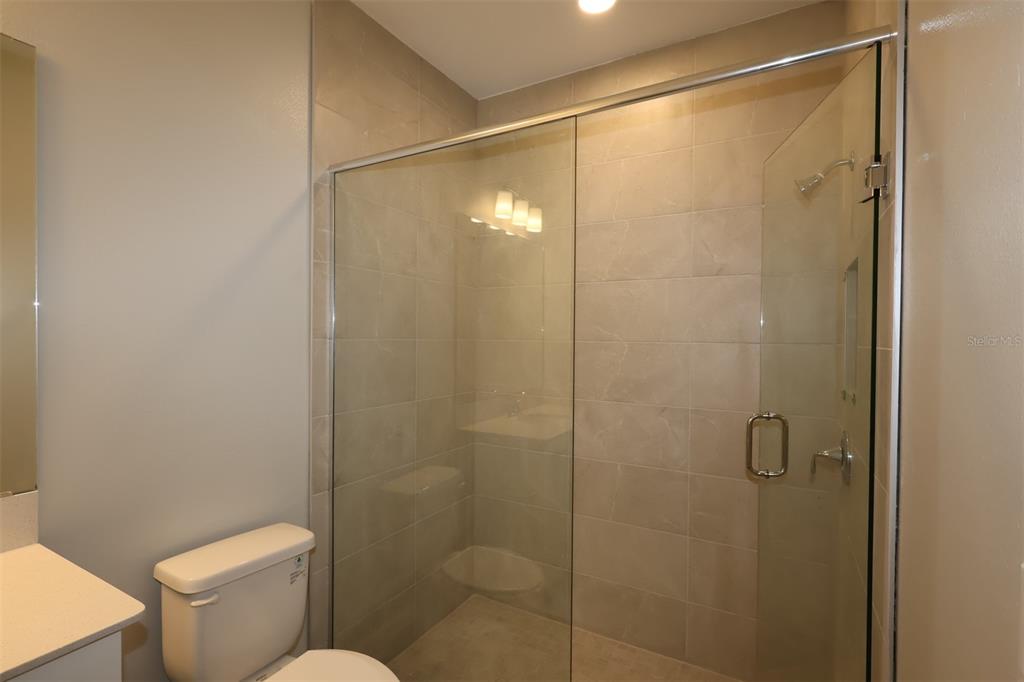 5184 Prairie Preserve Run St. Cloud, FL 34772 - Photo 6 of 36 a bathroom with a shower and toilet
