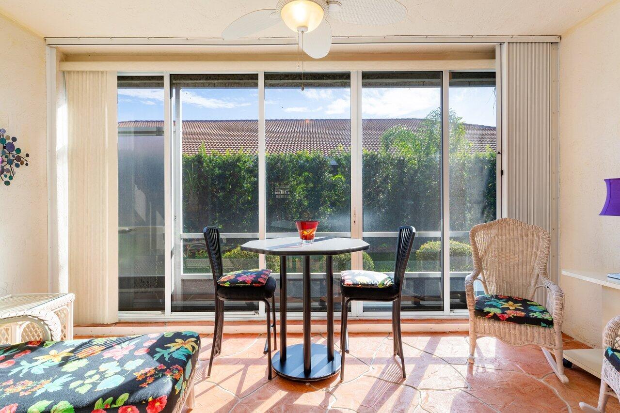 8398 Vía Serena Boca Raton, FL 33433 - Photo 22 of 50 a living room view with a floor to ceiling window and dining room