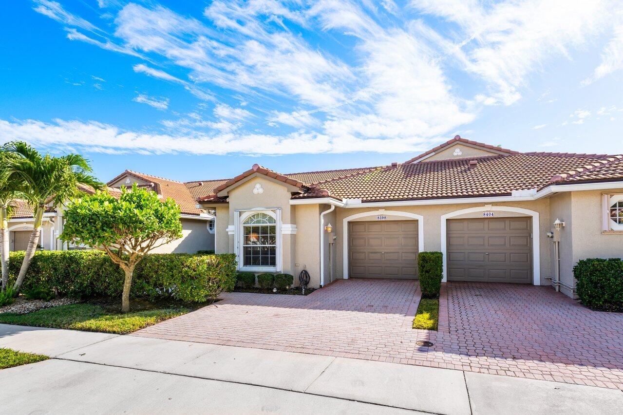 8398 Vía Serena Boca Raton, FL 33433 - Photo 50 of 50 a front view of a house with a garden and plants