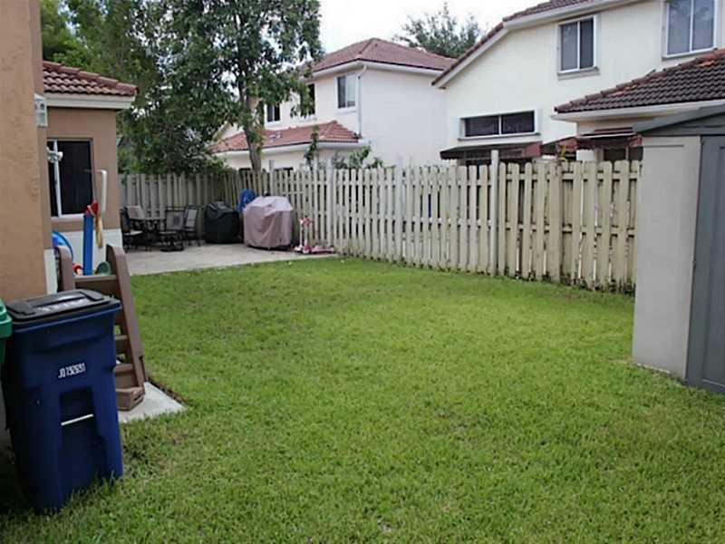 11270 Renaissance Road Cooper City, FL 33026 - Photo 11 of 17 a backyard of a house with a garden and barbeque oven