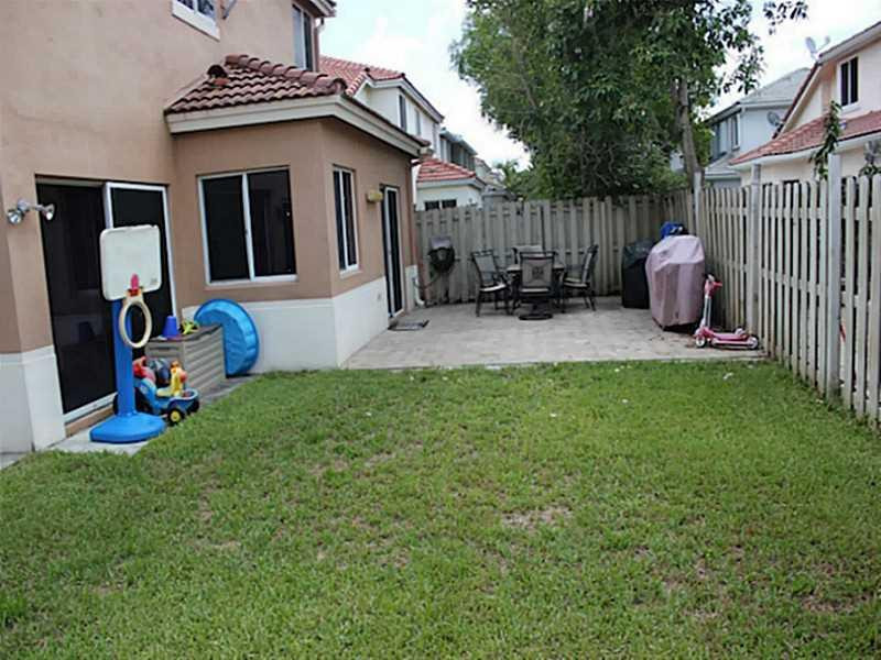 11270 Renaissance Road Cooper City, FL 33026 - Photo 12 of 17 a front view of a house with garden