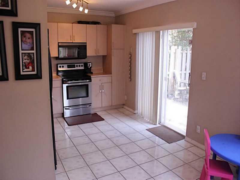 11270 Renaissance Road Cooper City, FL 33026 - Photo 8 of 17 a kitchen with stainless steel appliances a refrigerator and a stove top oven