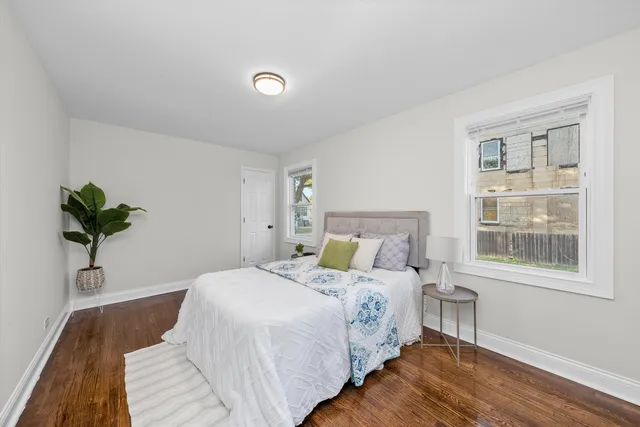 a bedroom with a bed and a potted plant