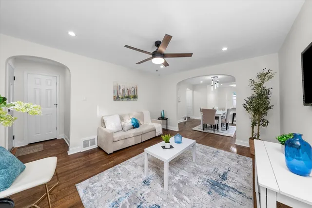 a living room with furniture and a potted plant