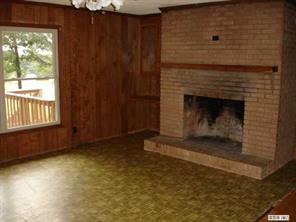 8504 A Smith Road Stanfield, NC 28163 - Photo 2 of 6 a view of an empty room with wooden floor and a fireplace