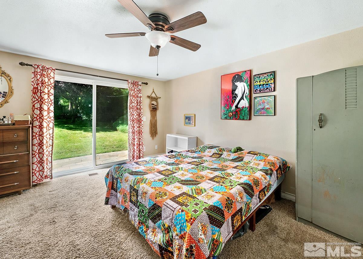 4155 Garlan Lane Reno, NV 89509 - Photo 13 of 24 a bed sitting in a bedroom next to a window