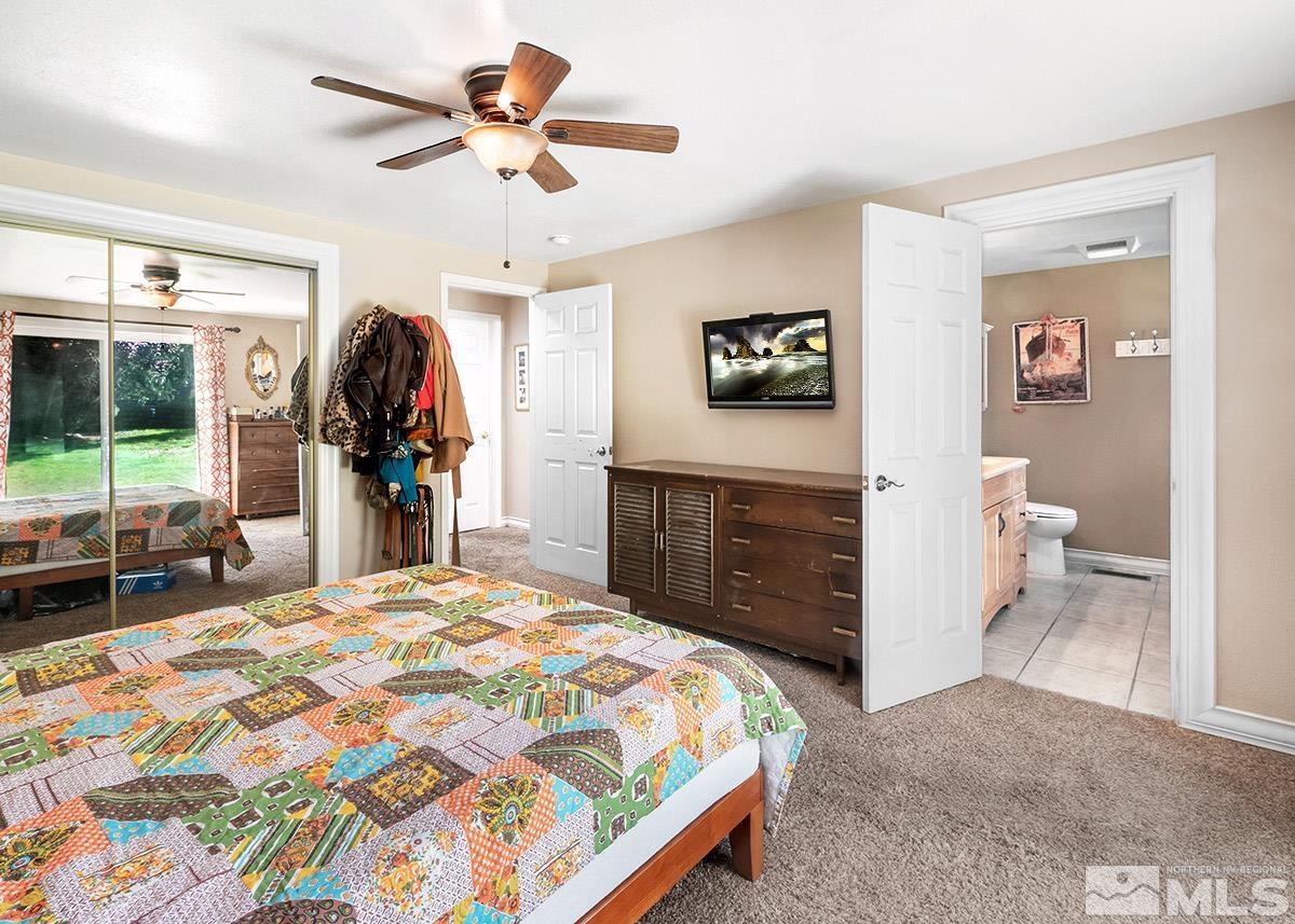 4155 Garlan Lane Reno, NV 89509 - Photo 14 of 24 a bedroom with a bed dresser and a large mirror