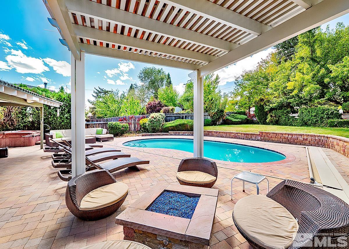 4155 Garlan Lane Reno, NV 89509 - Photo 19 of 24 a view of a patio with table and chairs potted plants with wooden floor and fence