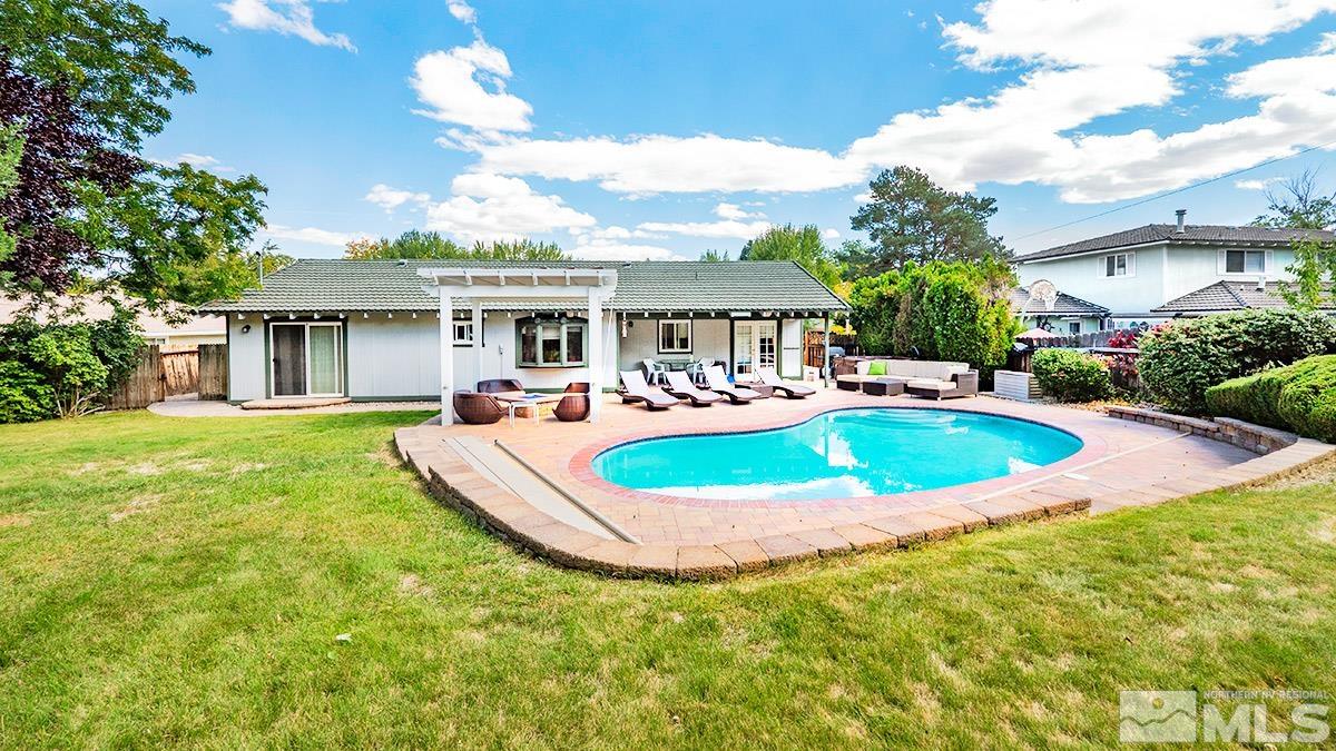 4155 Garlan Lane Reno, NV 89509 - Photo 20 of 24 a view of a house with a swimming pool and a yard