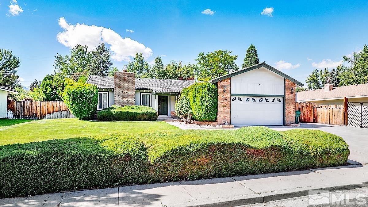 4155 Garlan Lane Reno, NV 89509 - Photo 2 of 24 a front view of a house with a yard and garage