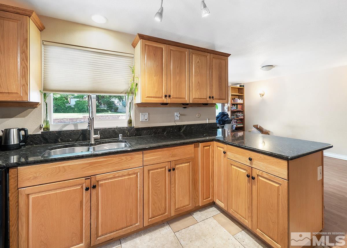4155 Garlan Lane Reno, NV 89509 - Photo 5 of 24 a kitchen with granite countertop white cabinets and white appliances