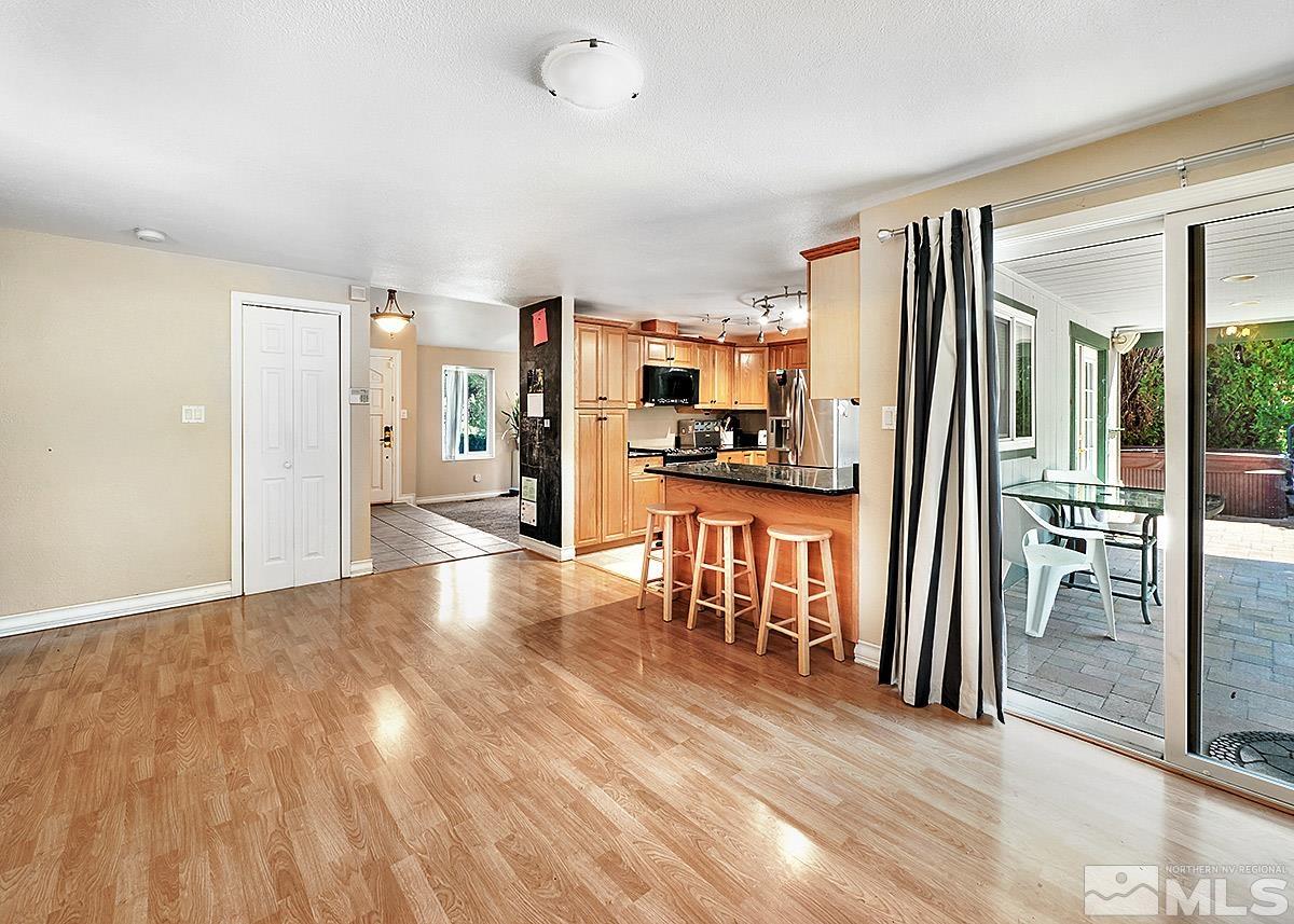 4155 Garlan Lane Reno, NV 89509 - Photo 7 of 24 a view of a kitchen with refrigerator stove and wooden floor