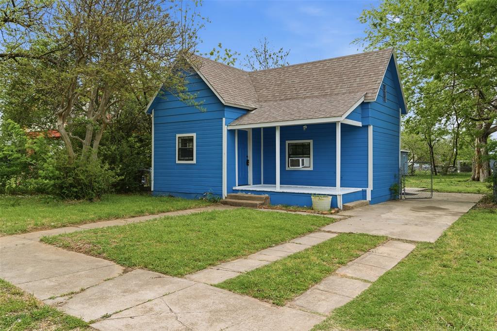 a front view of a house with a garden and yard