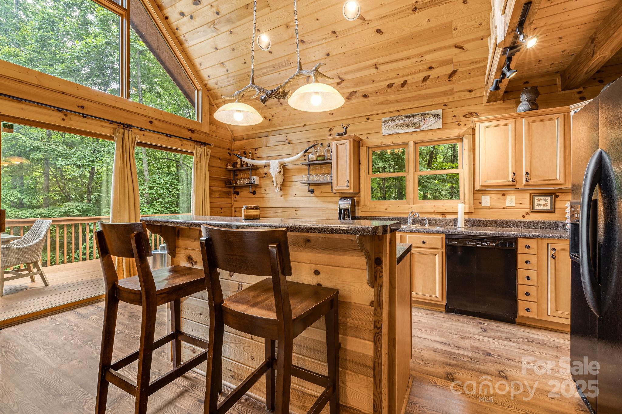 3617 Lonesome Mountain Road Marshall, NC 28753 - Photo 19 of 46 a dining area with a table chairs and a stove