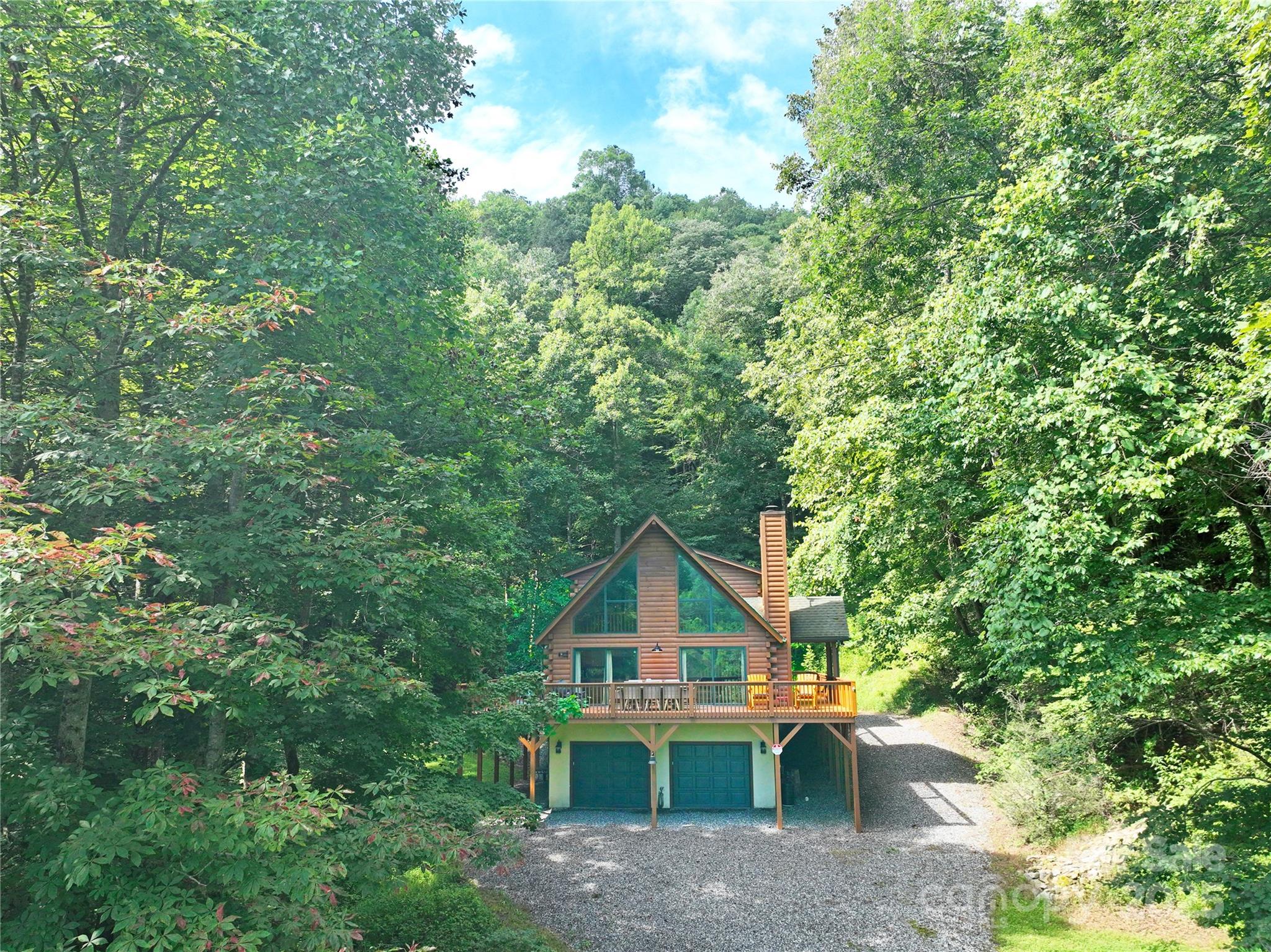 3617 Lonesome Mountain Road Marshall, NC 28753 - Photo 2 of 46 a front view of a house with a yard and garage