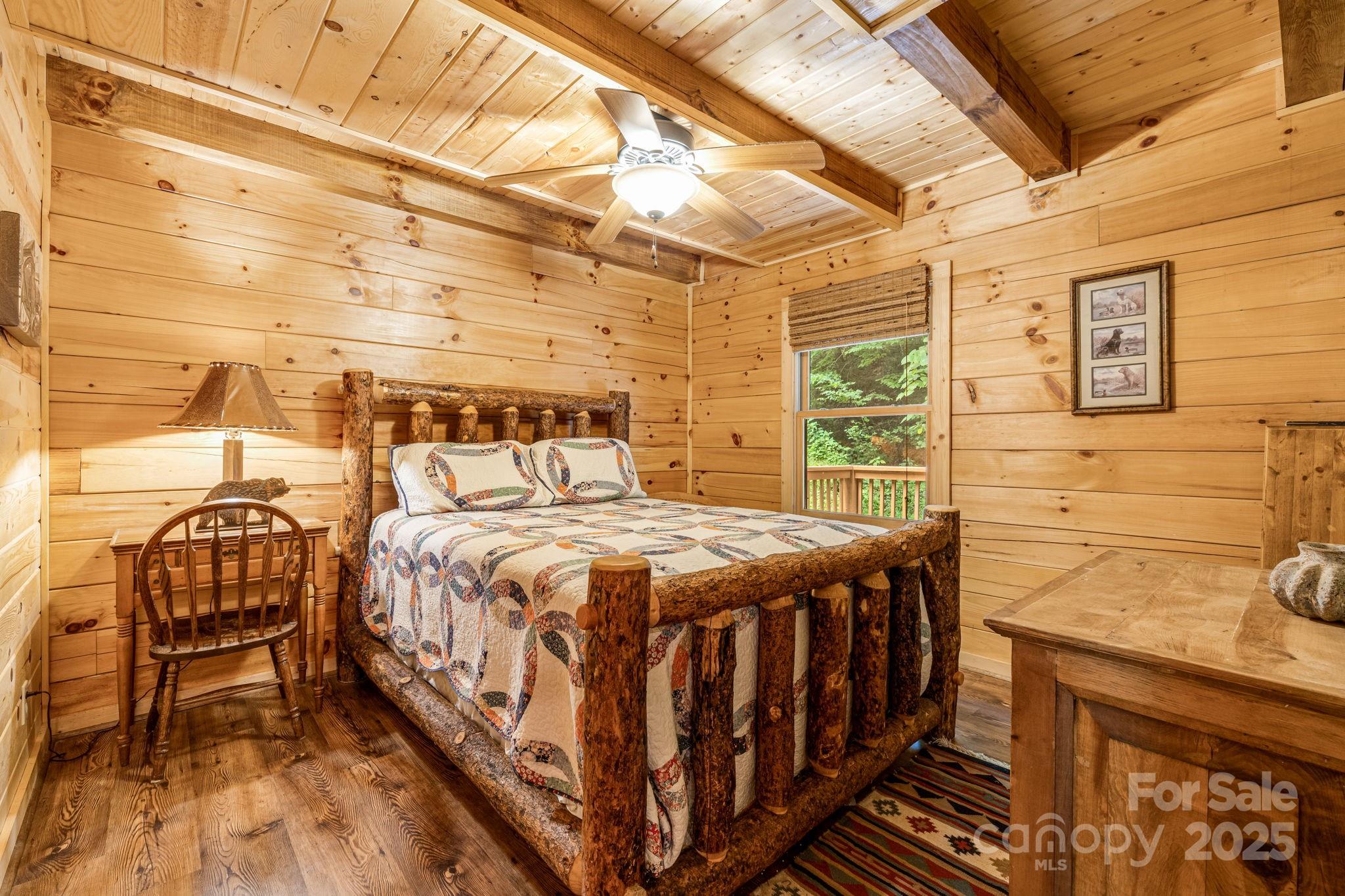 3617 Lonesome Mountain Road Marshall, NC 28753 - Photo 26 of 46 a bedroom with a bed and wooden floor