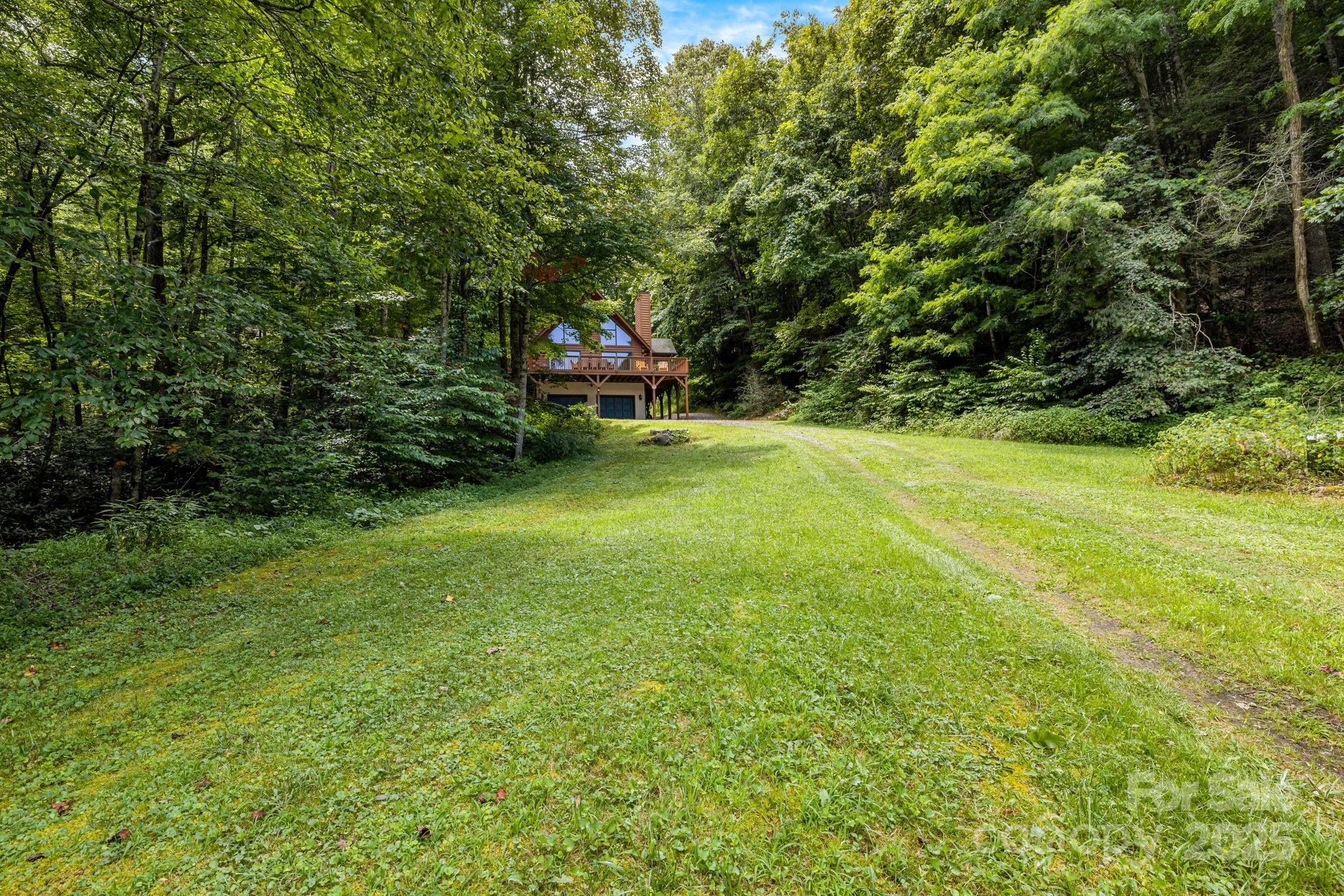 3617 Lonesome Mountain Road Marshall, NC 28753 - Photo 40 of 46 a backyard of a house with table and chairs