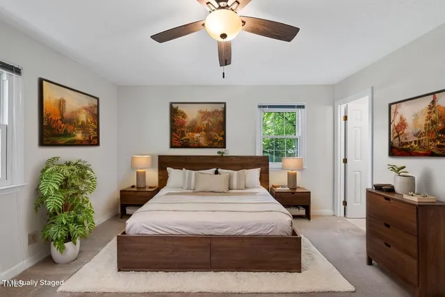 a bedroom with a large bed and a chandelier