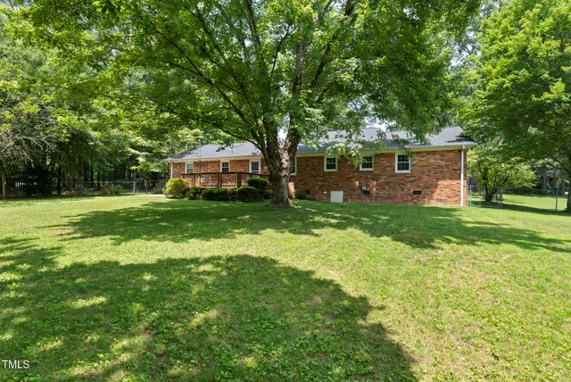 a front view of a house with yard and green space