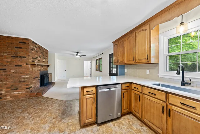a kitchen with stainless steel appliances granite countertop a sink and cabinets