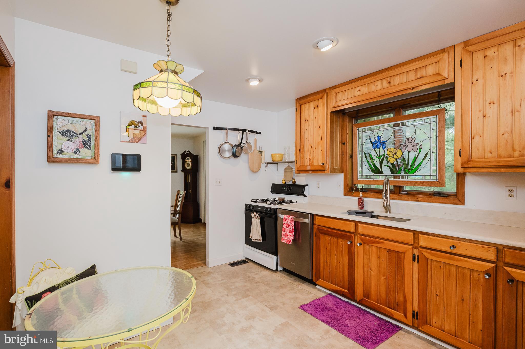 710 Magnolia Road Joppa, MD 21085 - Photo 11 of 58 a kitchen with stainless steel appliances granite countertop a sink dishwasher and a refrigerator with wooden floor