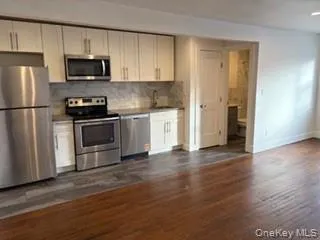 a kitchen with a refrigerator stove and microwave