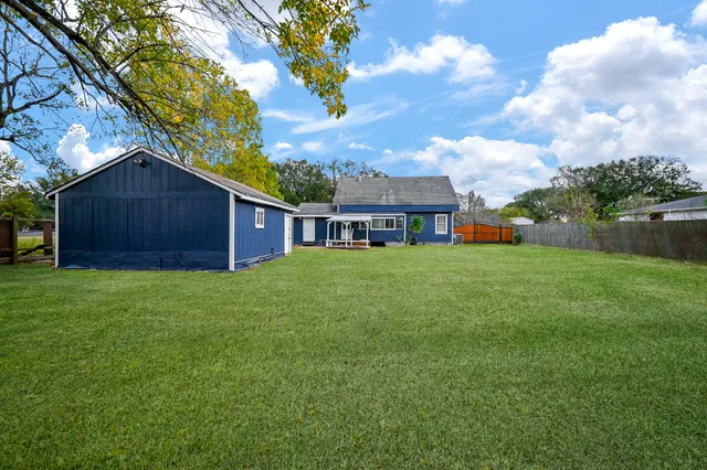 a view of house with backyard