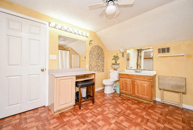 a spacious bathroom with a granite countertop sink and a mirror