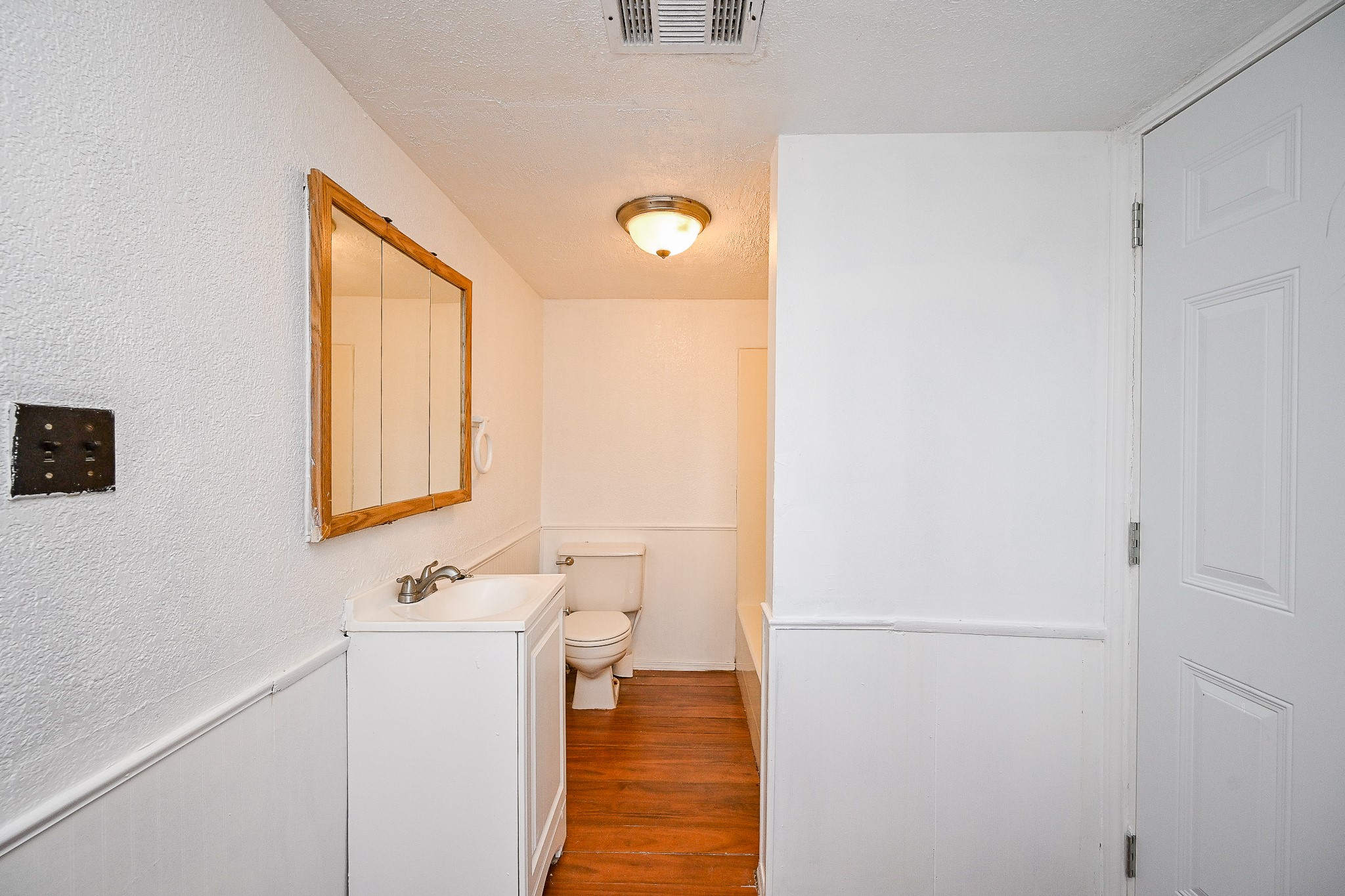 2806 Du Pont Street Pasadena, TX 77503 - Photo 14 of 20 a bathroom with a sink a toilet and a mirror