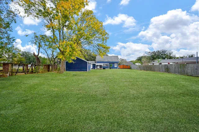 a view of house with backyard