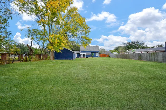 a view of house with backyard