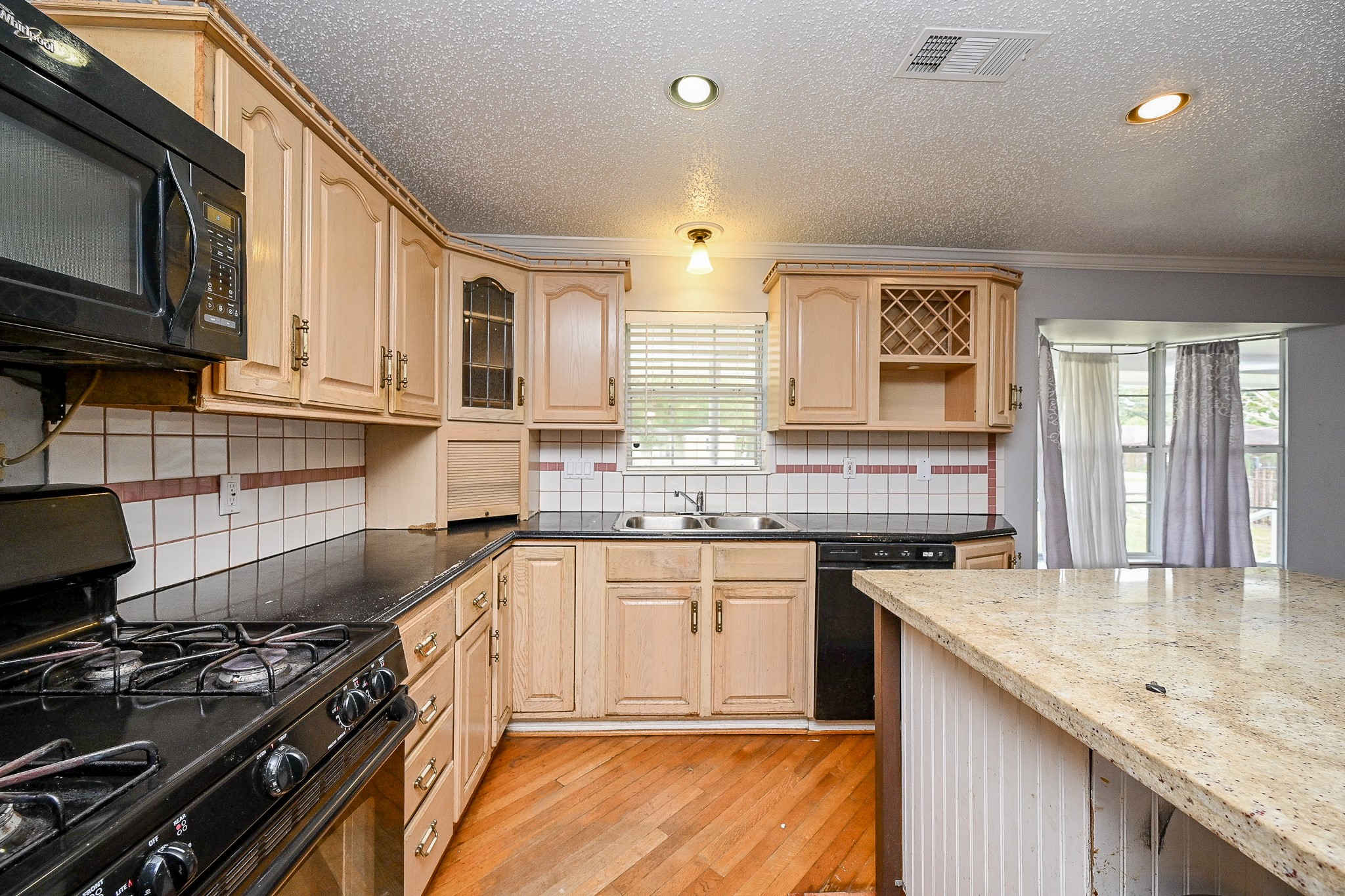 2806 Du Pont Street Pasadena, TX 77503 - Photo 5 of 20 a kitchen with stainless steel appliances granite countertop a sink stove and cabinets