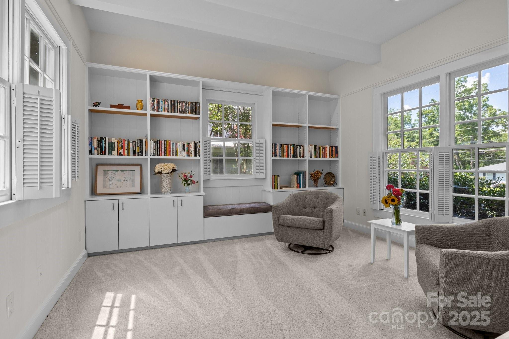560 Concord Road Davidson, NC 28036 - Photo 12 of 34 a living room with furniture and a book shelf