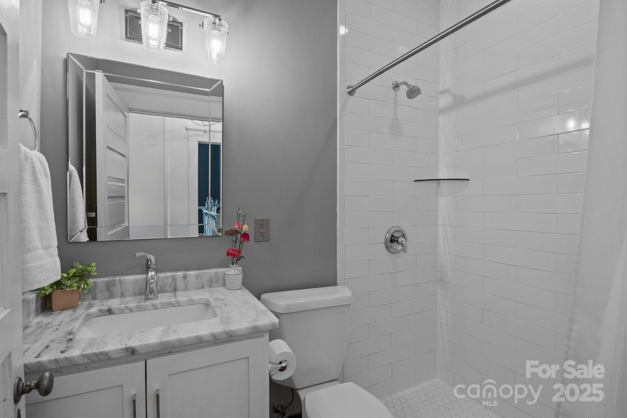 560 Concord Road Davidson, NC 28036 - Photo 17 of 34 a bathroom with a granite countertop sink toilet and shower