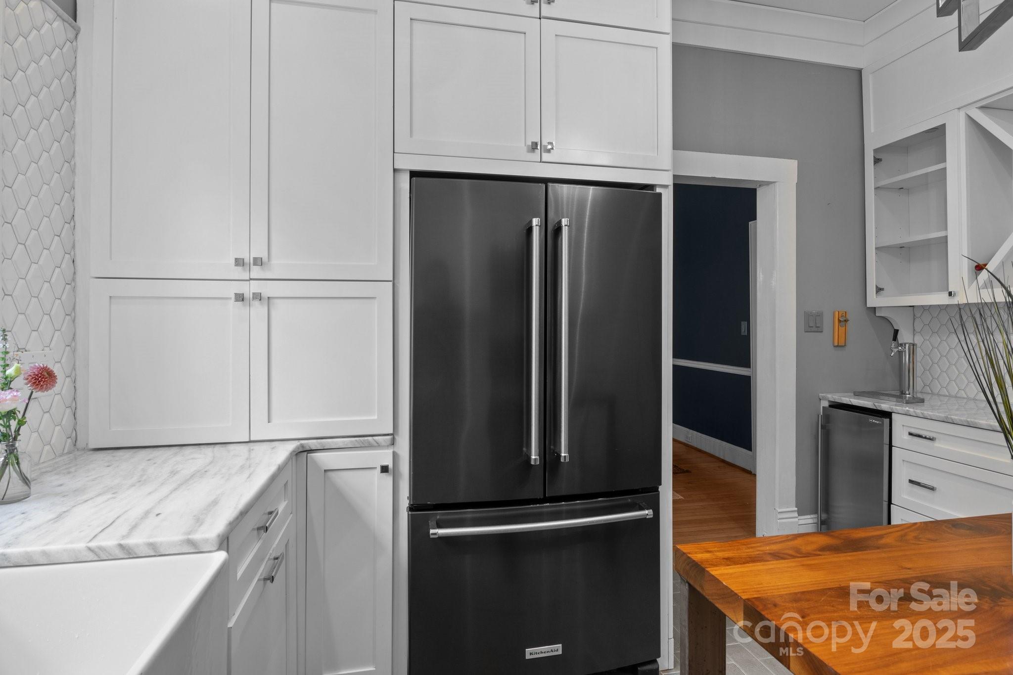 560 Concord Road Davidson, NC 28036 - Photo 20 of 34 a kitchen with granite countertop a refrigerator and a sink