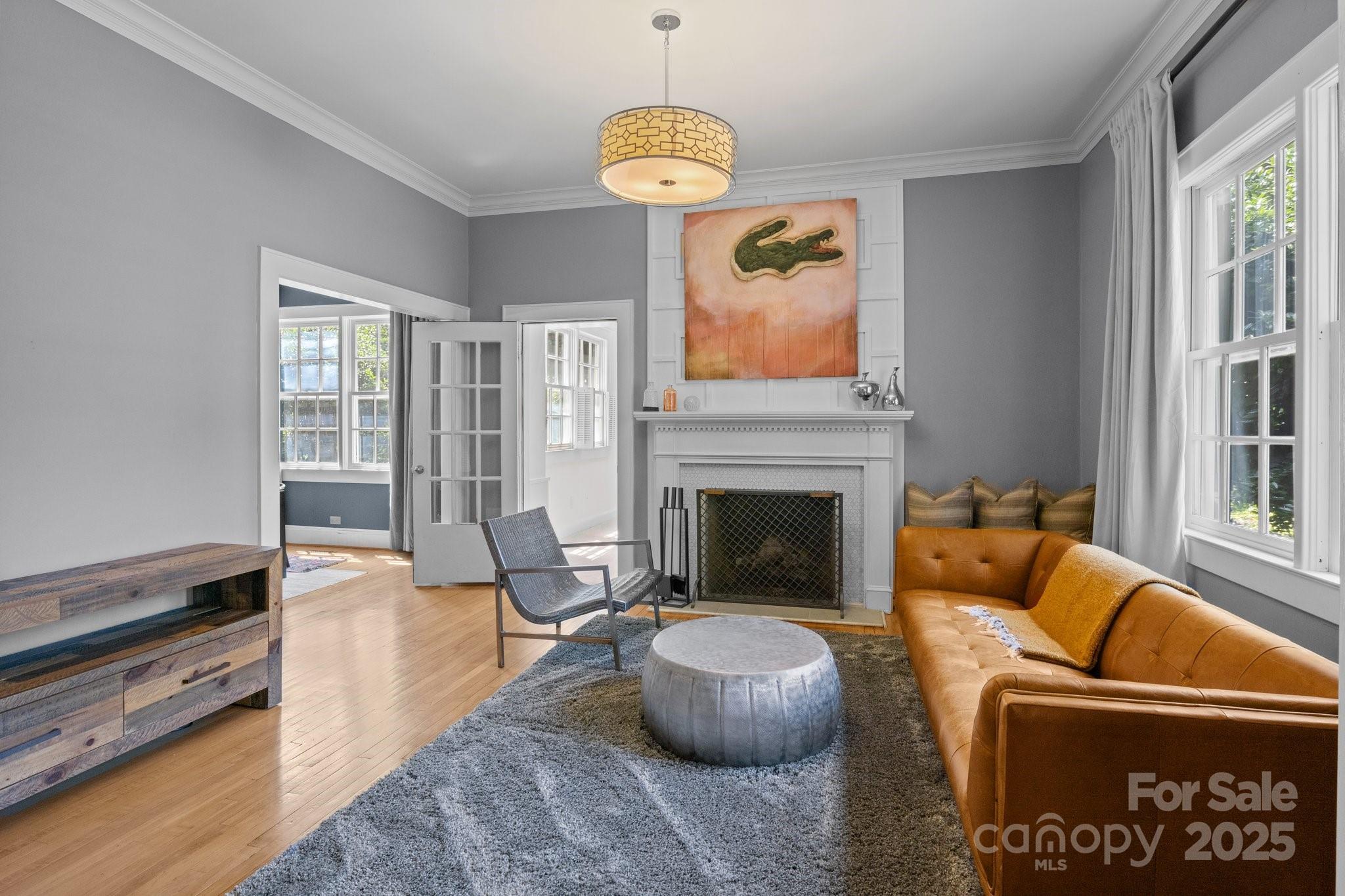 560 Concord Road Davidson, NC 28036 - Photo 10 of 34 a living room with furniture a fireplace and a large window