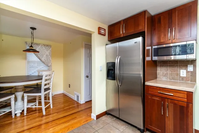 a kitchen with stainless steel appliances granite countertop a refrigerator and a stove