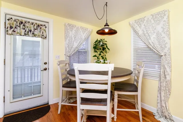 a view of a hallway with wooden floor and chandelier
