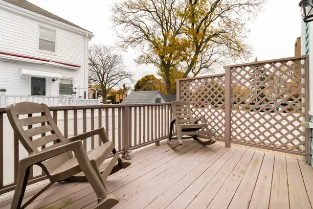a view of a wooden deck with furniture
