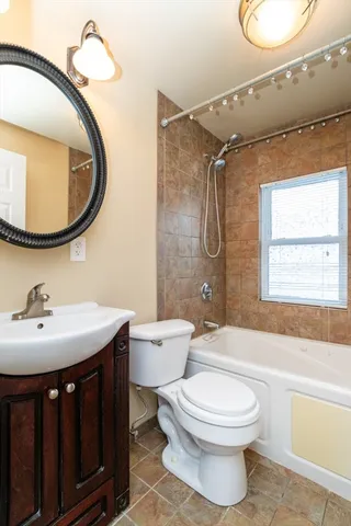 a bathroom with a toilet a sink and a mirror