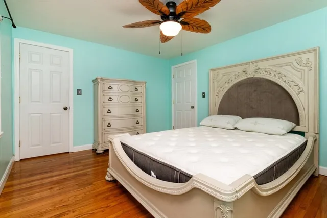a spacious bedroom with a bed and a chandelier